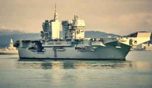 Marinai Royal Navy su ponte di comando simulato con overlay tecnologici durante addestramento Selborne per warfighting readiness.